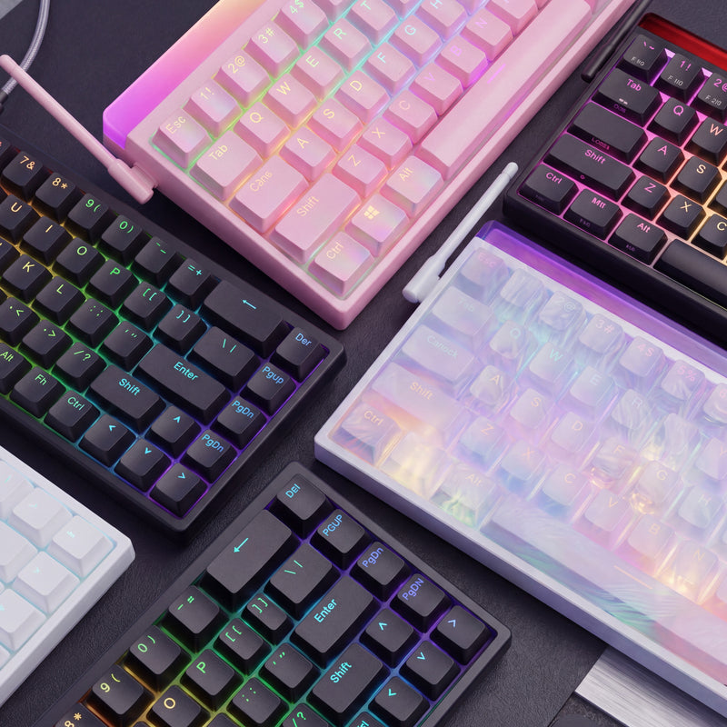 Collection of colorful mechanical keyboards on a dark surface