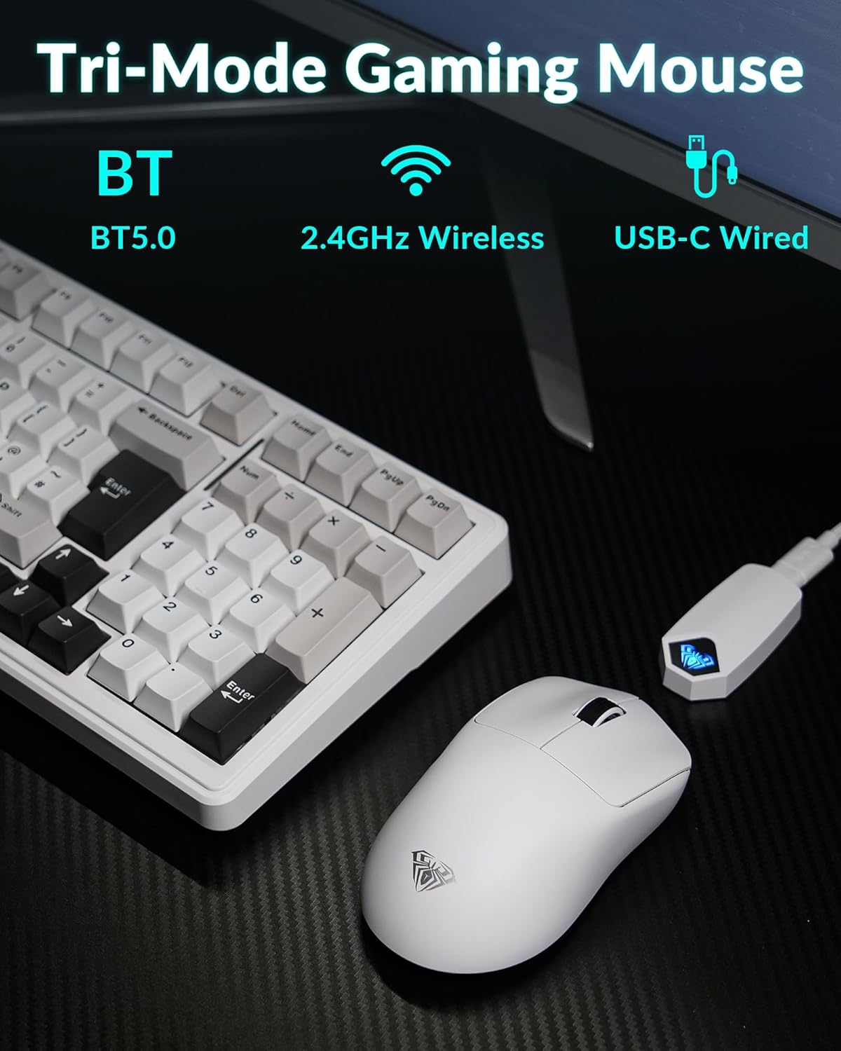 Tri-mode gaming mouse with BT, 2.4GHz wireless, and USB-C wired connections next to a keyboard on a dark surface.